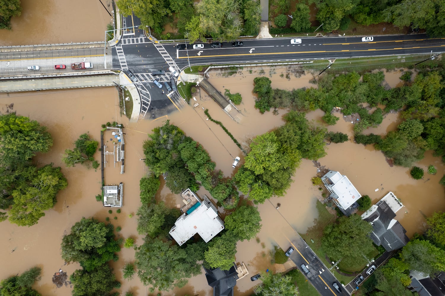 Peachtree Creek spills over its banks in Atlanta on Friday, Sept. 27, 2024 following a night of heavy rain from Hurricane Helene. Northside Drive NW is seen at the top of the photo. Ben Gray for the Atlanta Journal-Constitution