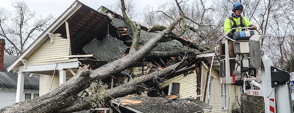 Adam Smith with Green Tree Service surveys the damage on West Chappell Street in Griffin.