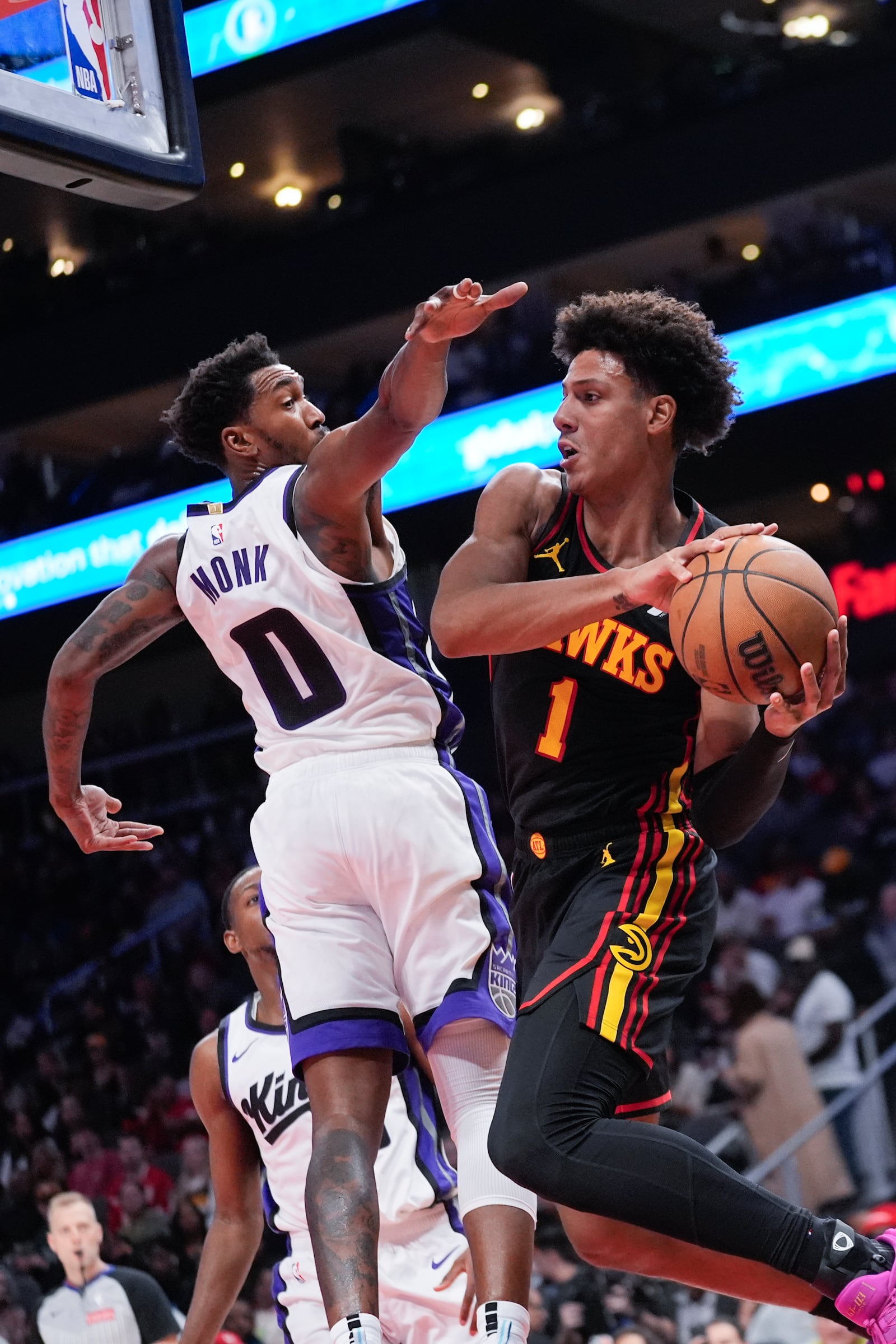 Atlanta Hawks forward Jalen Johnson (1) tyries to pass around Sacramento Kings guard Malik Monk (0) during the first half of an NBA basketball game, Friday, Nov. 1, 2024, in Atlanta. (AP Photo/ John Bazemore )