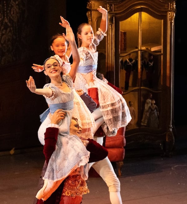 The central character, Marie, is portrayed in Possokhov’s Nutcracker as a bookworm, complete with eyeglasses. This year’s production features several casts. Here, Isabella Kessler, front, as young Marie, dances in the Act I holiday party.