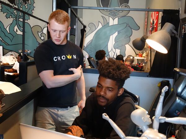 Chris Boyd, a new client, is getting his first tattoo from Corey Davis earlier this month at City of Ink in Atlanta. He wants a pocket watch tattoo on his left rib cage which represents his father, who died six years ago when he was 16. CREDIT: Rodney Ho/ rho@ajc.com