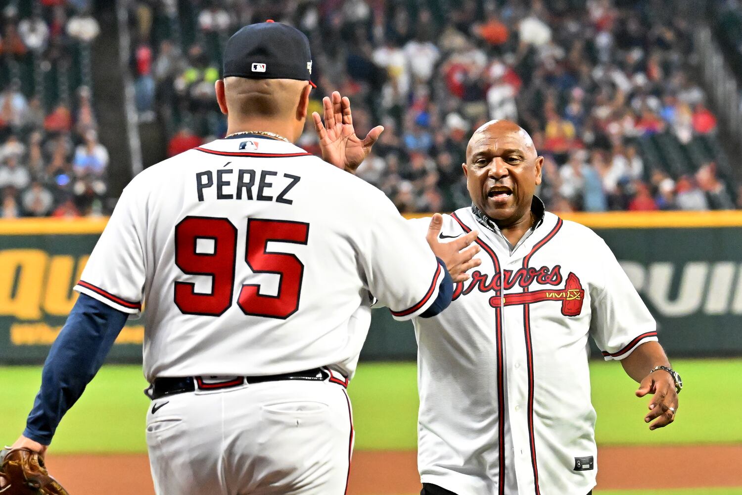 Braves great Terry Pendleton is greeted after throwing out the ceremonial first pitch during game two of the National League Division Series baseball game between the Braves and the Phillies at Truist Park in Atlanta on Wednesday, October 12, 2022. (Hyosub Shin / Hyosub.Shin@ajc.com)