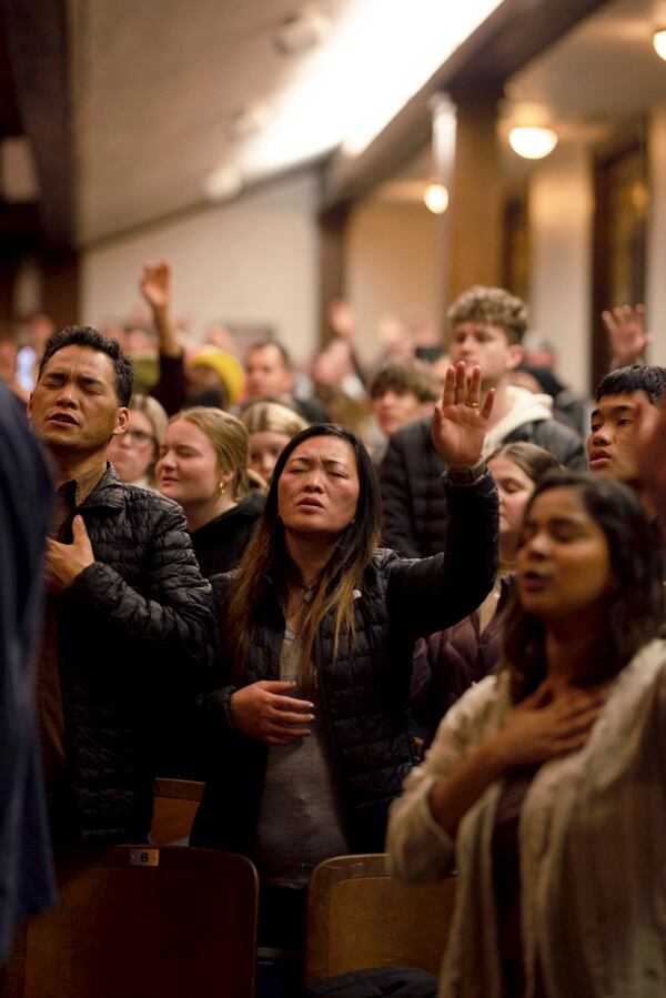 Attendees during worship inside Hughes Chapel on the campus of Asbury University in Wilmore, Ky., on Feb. 18, 2023. Over two weeks, more than 50,000 people descended on a small campus chapel to experience the nation’s first major spiritual revival in decades — one driven by Gen Z. (Jesse Barber/The New York Times)