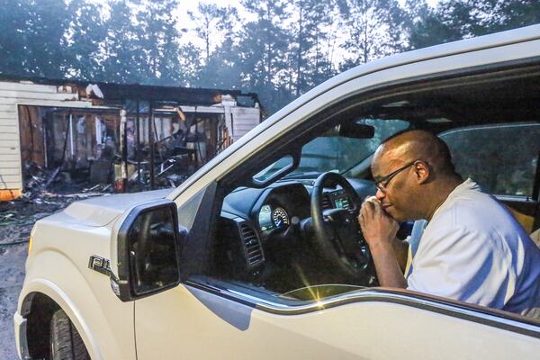 Bill Thomas cried in front of his mother’s burned home after a fire in DeKalb County. JOHN SPINK / JSPINK@AJC.COM