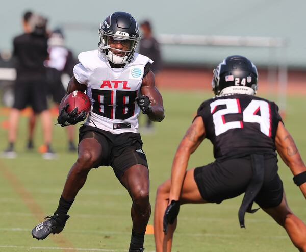 Falcons rookie wide receiver Frank Darby works against cornerback A.J. Terrell after catching a pass on the third day of training camp practice on Saturday, July 31, 2021, in Flowery Branch. (Curtis Compton / Curtis.Compton@ajc.com)