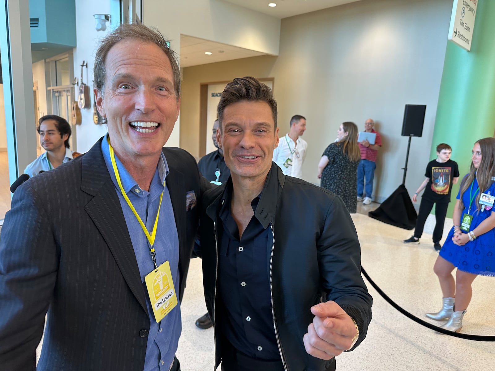 Fox FM host Tom Sullivan gave Ryan Seacrest his first job as a radio host on Star 94 in the early 1990s when Seacrest was a teenager. They reunited Oct. 11, 2024 at the new Seacrest Studios at Arthur M. Blank hospital. RODNEY HO/rho@ajc.com