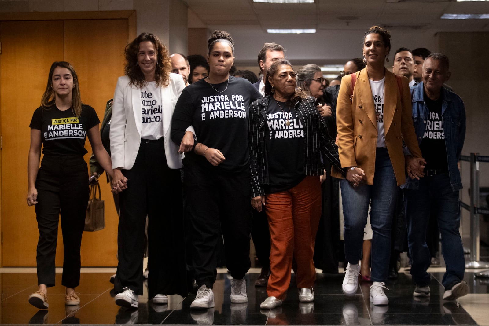 Family members of slain councilwoman Marielle Franco — including, from center left, daughter Luyara Franco, mother Marinete da Silva, and sister Anielle Franco, Brazil’s minister for racial equality — leave the courtroom after a judge sentenced two former police officers for the 2018 murder of Franco and her driver Anderson Gomes, at the Court of Justice in Rio de Janeiro, Thursday, Oct. 31, 2024. (AP Photo/Bruna Prado)