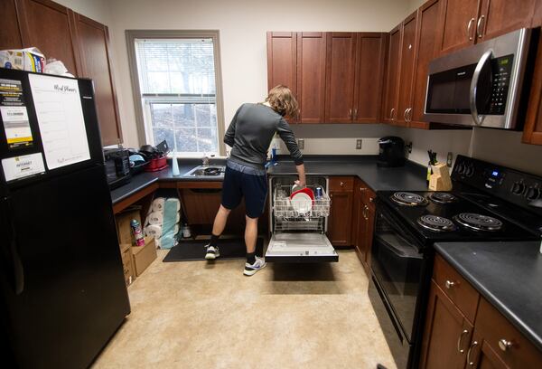 Kennesaw State University student Caleb McMaster takes care of some dishes in the ASCEND living-learning village where he lives Friday, November 13, 2020.   STEVE SCHAEFER / SPECIAL TO THE AJC 