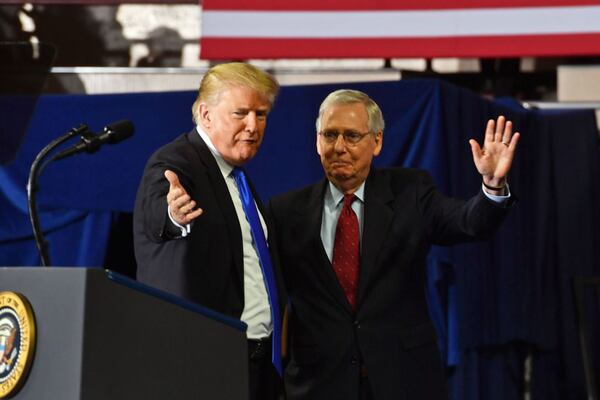 Former President Donald Trump, left, has pushed to remove Mitch McConnell as the Republican leader in the U.S. Senate. Meanwhile, Georgia Republicans running for the Senate show no interest in getting involved. (Nicholas Kamm/AFP via Getty Images/TNS)