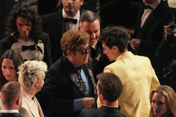 Elton John, left, and Timothee Chalamet in the audience during the Oscars on Sunday, March 2, 2025, at the Dolby Theatre in Los Angeles. (AP Photo/Chris Pizzello)