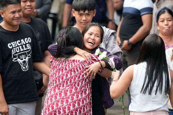 Mary Jane Veloso, center, a Filipino woman who spent almost 15 years in an Indonesian prison for drug trafficking and was nearly executed by firing squad in 2015, is reunited with her family as she arrives at the Correctional Institution for Women in Mandaluyong, Philippines Wednesday, Dec. 18, 2024. (AP Photo/Aaron Favila)