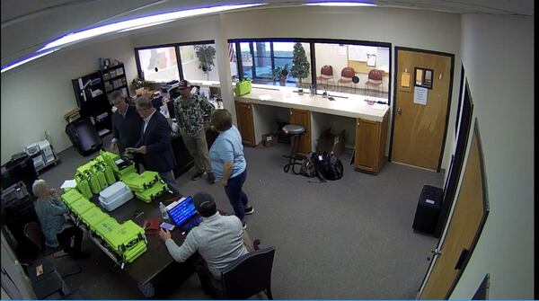 Surveillance video of the Coffee County elections office shows, from left, Coffee County Republican Party Chairwoman Cathy Latham (seated); Paul Maggio of SullivanStrickler, an Atlanta data firm that supporters of then-President Donald Trump hired to copy the state's election software; bail bondsman Scott Hall; county election board member Eric Chaney; an unnamed analyst; and county Elections Director Misty Hampton. Source: Coffee County