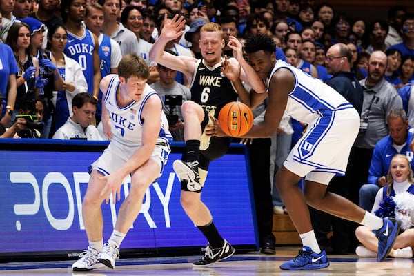 Wake Forest's Cameron Hildreth (6) battles Duke's Kon Knueppel (7) and Patrick Ngongba II, right, for the ball during the first half of an NCAA college basketball game in Durham, N.C., Monday, March 3, 2025. (AP Photo/Ben McKeown)