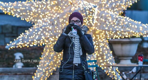 Taniesha Alexander warms up on coffee at 15th and Peachtree streets Wednesday morning. JOHN SPINK / JSPINK@AJC.COM