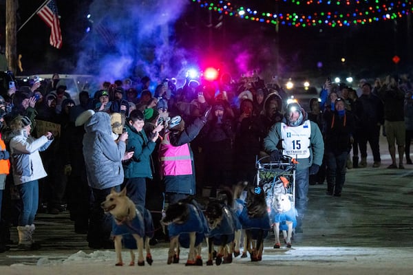 Jessie Holmes mushes down Front Street on his way to winning the Iditarod Trail Sled Dog Race early Friday morning, March 14, 2025 in Nome. (Loren Holme/Anchorage Daily News via AP)