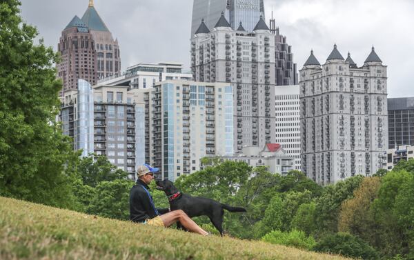 File photo of Ron Hoffman enjoying Piedmont Park in midtown with his black Labrador Retriever, Georgia. (John Spink / John.Spink@ajc.com)


