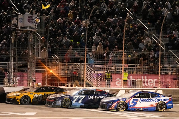 Christopher Bell, left, wins a NASCAR Cup Series auto race, Sunday, Feb. 23, 2025, in Hampton, Ga. (AP Photo/Mike Stewart)