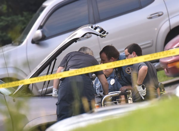 Gwinnett County police detectives gather at the scene of a homicide investigation. 