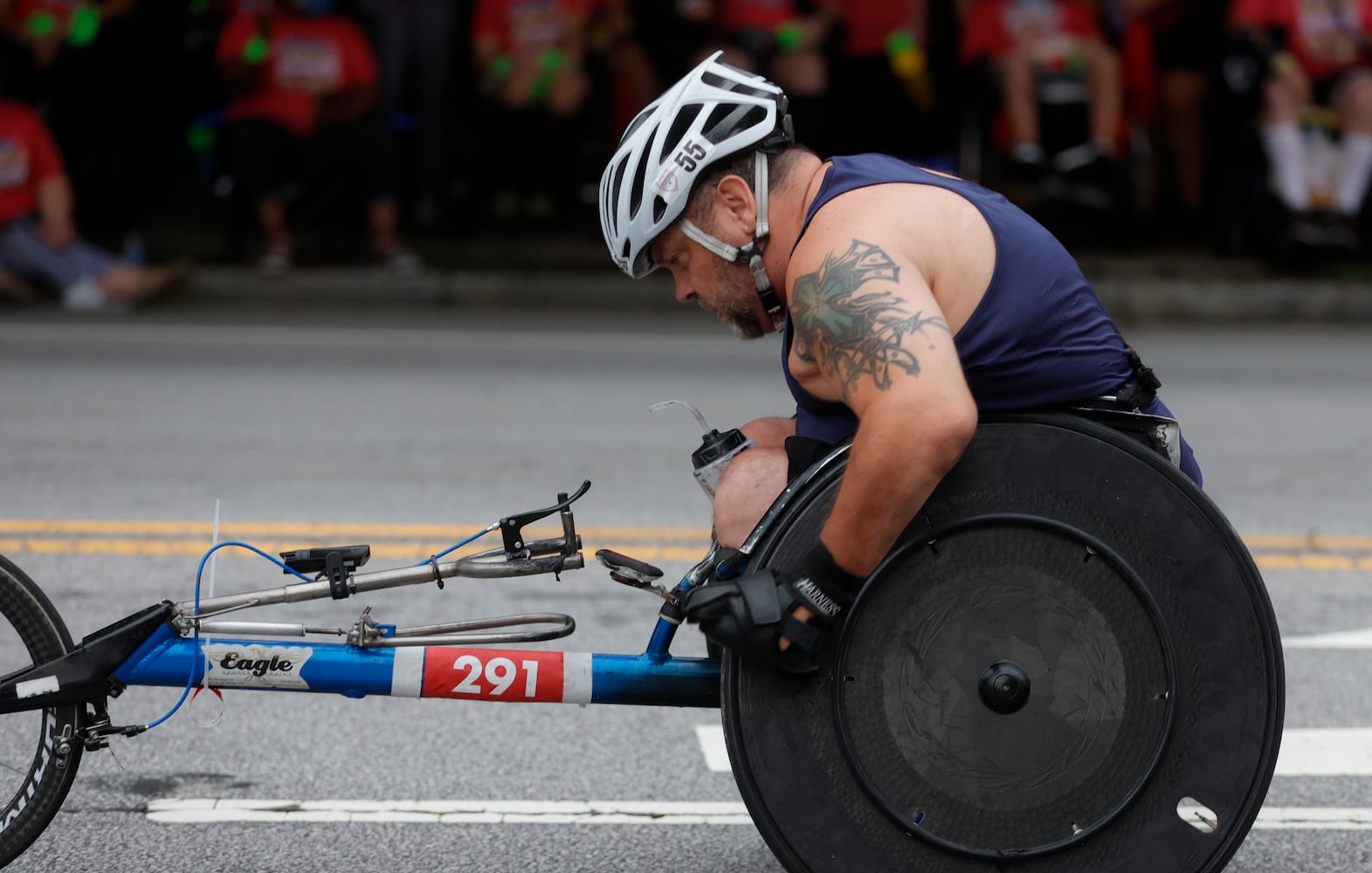 A mens wheeler makes his way along Peachtree Street during the 54th running of the Atlanta Journal-Constitution Peachtree Road Race in Atlanta on Tuesday, July 4th, 2023.   (Natrice Miller / Natrice.Miller@ajc.com)