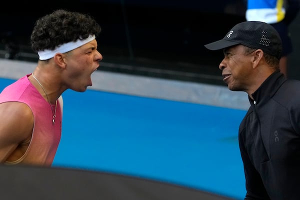 Ben Shelton of the U.S. celebrates with his father Bryan, right, after defeating Lorenzo Sonego of Italy in their quarterfinal match at the Australian Open tennis championship in Melbourne, Australia, Wednesday, Jan. 22, 2025. (AP Photo/Asanka Brendon Ratnayake)