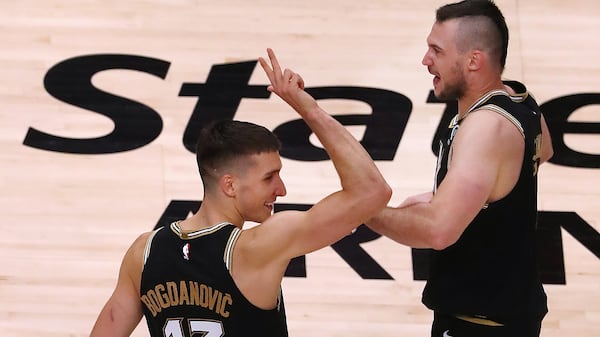 Hawks guard Bogan Bogdanovic (left) celebrates with forward Danilo Gallinari (right) after Gallinari slammed in a dunk for two points of 113-96 victory in Game 4 of first-round NBA playoff matchup against the New York Knicks Sunday, May 30, 2021, at State Farm Arena in Atlanta. (Curtis Compton / Curtis.Compton@ajc.com)