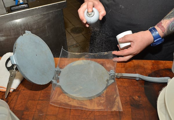 Chef Clevenger shows how to use a tortilla press in step 3. (Tip: if you don’t have a tortilla press, you may use a heavy iron skillet to flatten the dough).  Food styling by Alma Cocina chef Chad Clevenger. (Chris Hunt/Special)