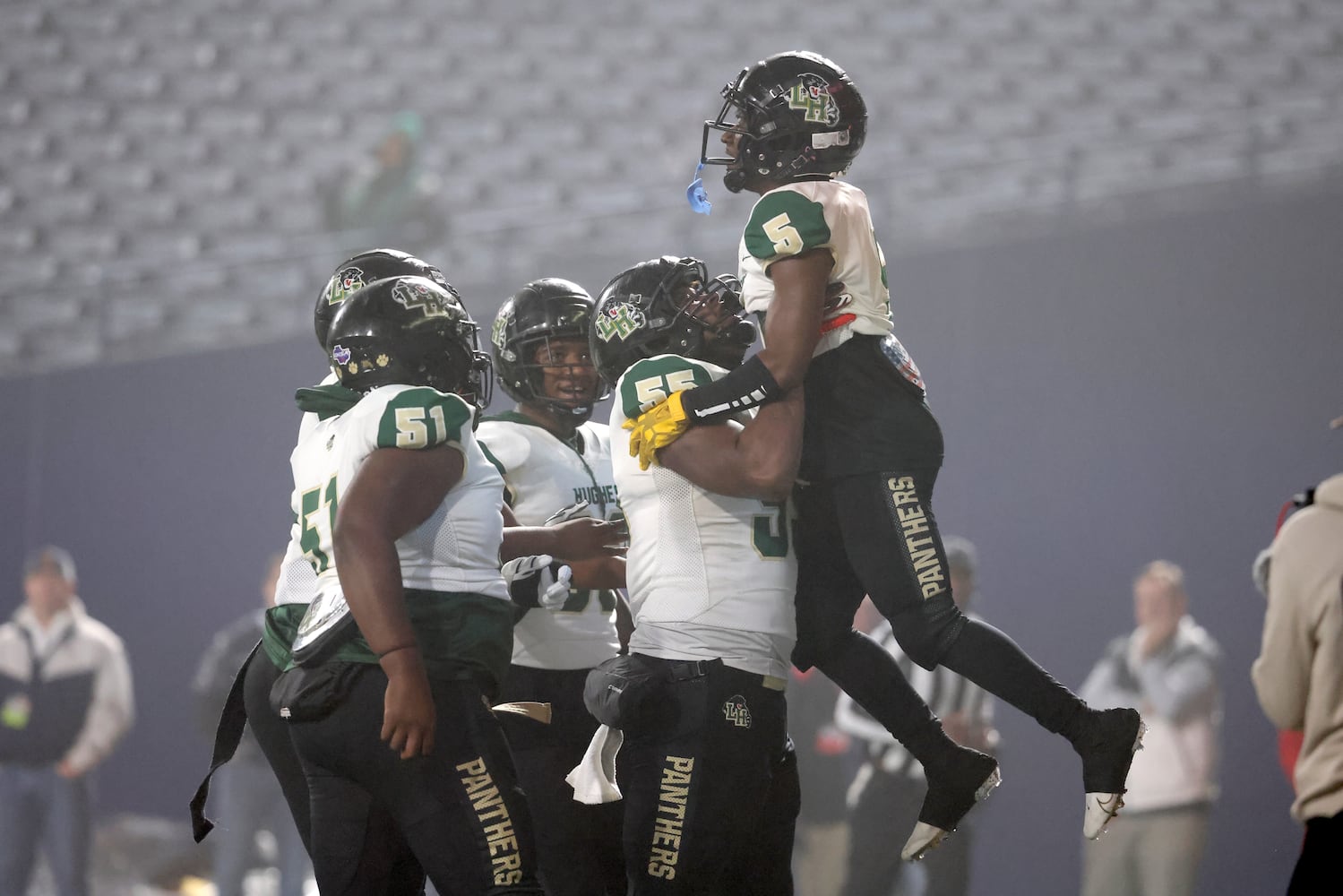 Langston Hughes wide receiver Armani Tookes (5) celebrates his receiving touchdown with offensive lineman Johnathan Hughley (55) during the first half against Buford in the Class 6A state title football game at Georgia State Center Parc Stadium Friday, December 10, 2021, Atlanta. JASON GETZ FOR THE ATLANTA JOURNAL-CONSTITUTION