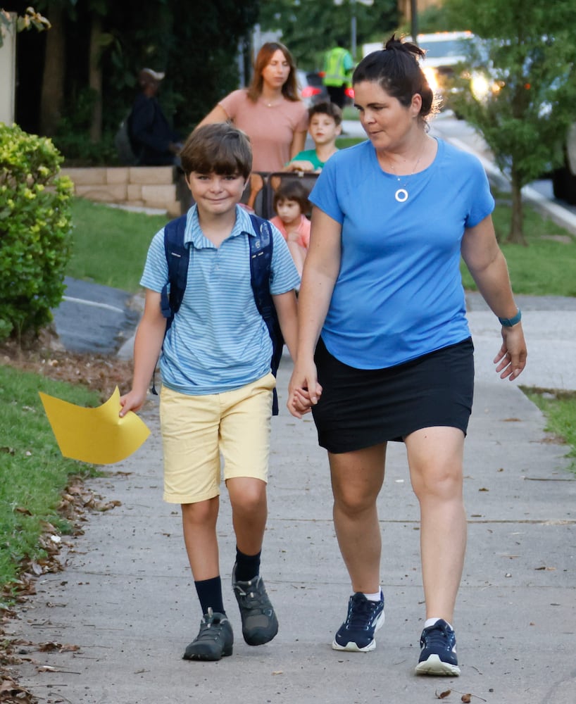 Ashley and fifth grader Sam Pollet walk to school for the first day of school at Springdale Park Elementary School in Atlanta on Tuesday, August 1, 2023.   (Bob Andres for the Atlanta Journal Constitution)