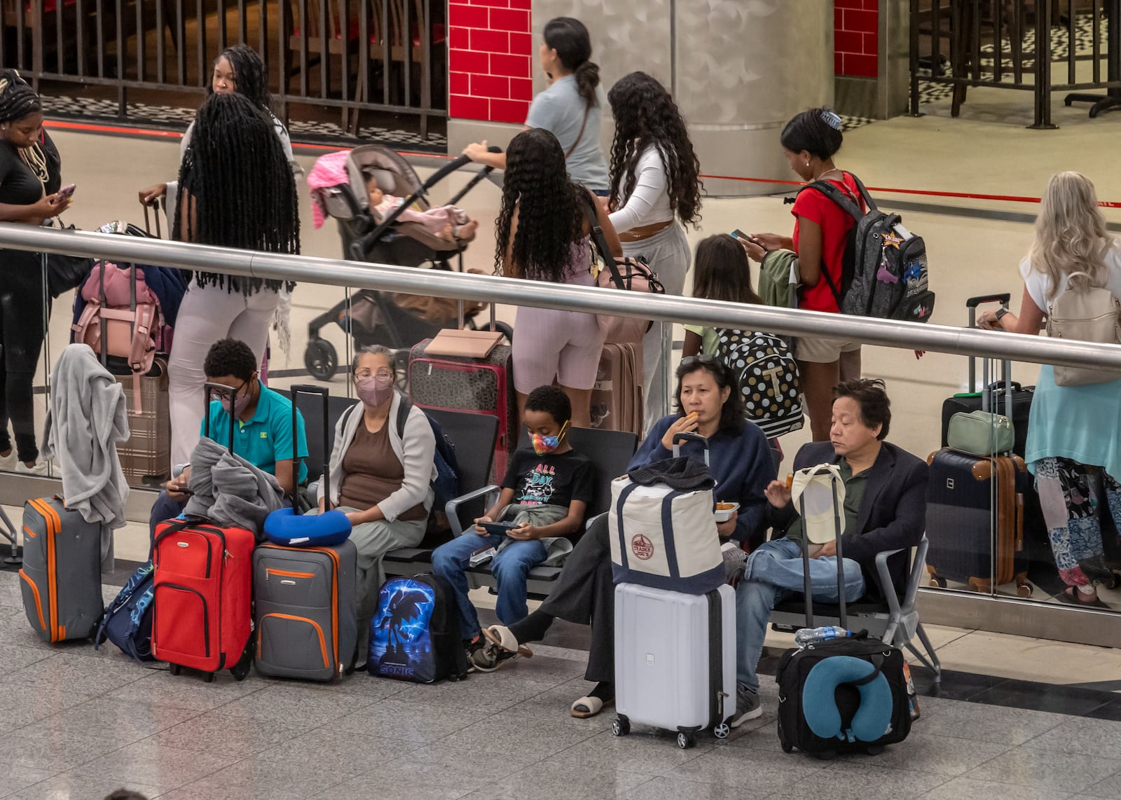 Air Travelers on the South Terminal stormed ticket counters Friday, July 19, 2024 as a massive outage is affected Microsoft users around the globe, disrupting airlines, railways, banks, stock exchanges and other businesses. U.S. airlines including Delta, United and American grounded flights, and airlines and airports across the globe are affected. The source of the outage involves security updates from cybersecurity firm CrowdStrike.  (John Spink/AJC)