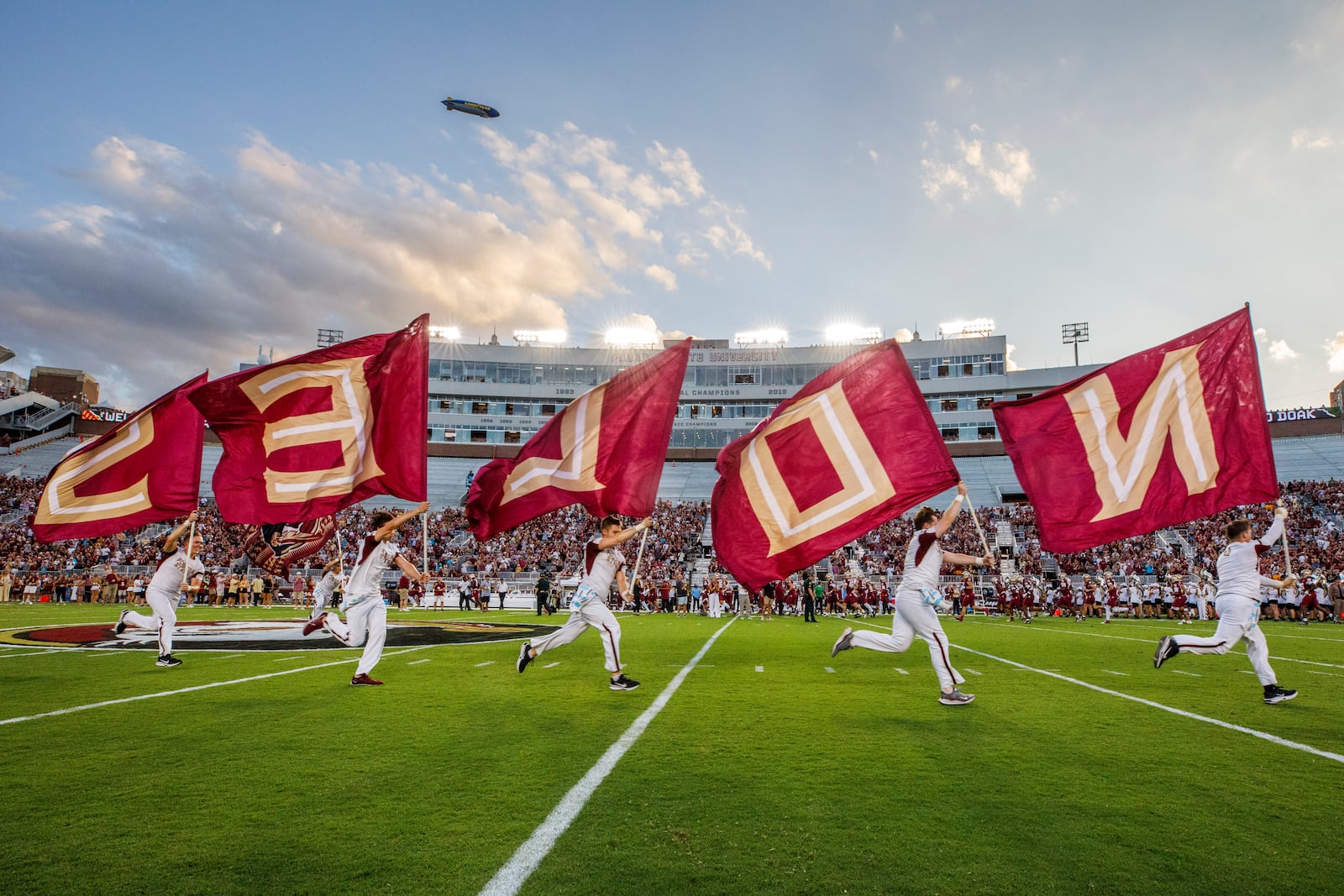 FILE - The Florida State flag squad runs prior to the start of an NCAA college football game against Boston College, Sept. 2, 2024, in Tallahassee, Fla. (AP Photo/Colin Hackley, File)