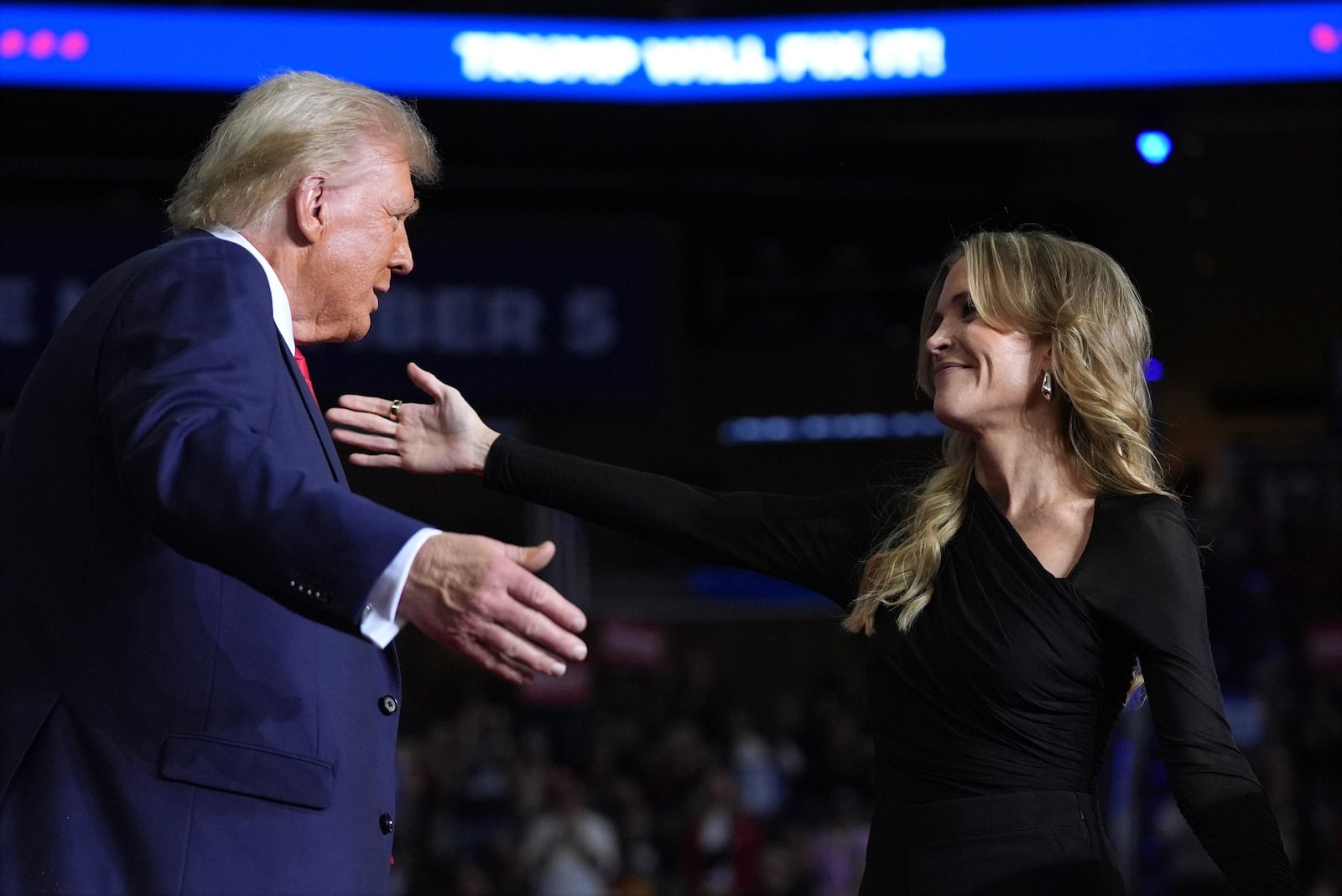 Republican presidential nominee former President Donald Trump greets Megyn Kelly at a campaign rally at PPG Paints Arena, Monday, Nov. 4, 2024, in Pittsburgh, Pa. (AP Photo/Evan Vucci)