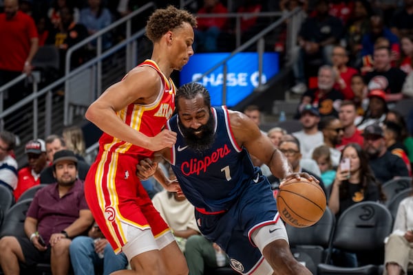 Los Angeles Clippers guard James Harden (1), right, attempts to move the ball against Atlanta Hawks guard Dyson Daniels (5), left, during the first half of an NBA basketball game, Friday, March 14, 2025, in Atlanta. (AP Photo/Erik Rank)