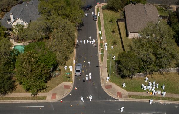 Investigators work at the scene of a bombing on Dawn Song Drive in the Travis Country neighborhood on Monday.    JAY JANNER / AMERICAN-STATESMAN