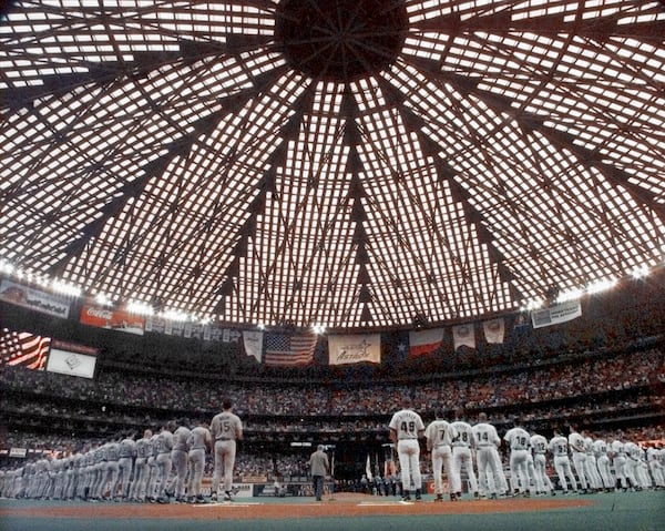 FILE- The San Diego Padres, left, and the Houston Astros, right, line up for the playing of the National Anthem before the first game of the National League division playoffs in the Houston Astrodome, Sept. 29, 1998. (AP Photo/David J. Phillip, File)