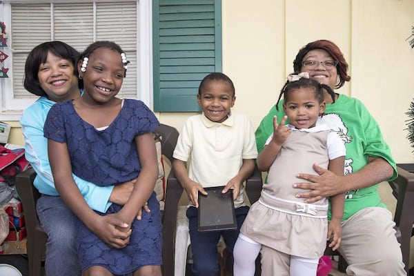 Twin sisters Priscilla (left) and Patricia (right) Moses have fostered more than 20 children, but now life revolves around their three adopted children: Ariah (from left), 9, Kristopher, 8, and Karrigan, 2.