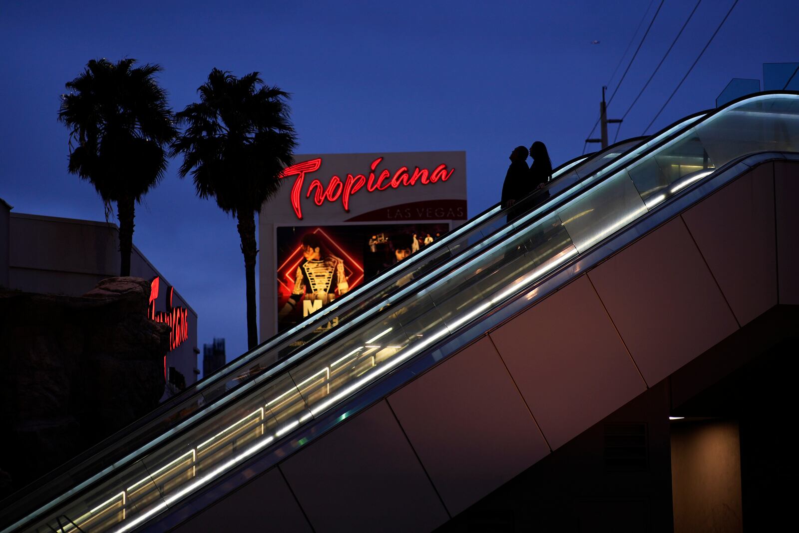 FILE - People ride an escalator outside of the Tropicana hotel-casino Thursday, March 28, 2024, in Las Vegas. (AP Photo/John Locher, File)