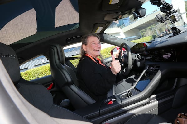 AJC writer and contributor Mary Welch nervously posing before driving at the Porsche Experience Center Atlanta on International Women's Day. (Tyson Horne / tyson.horne@ajc.com)