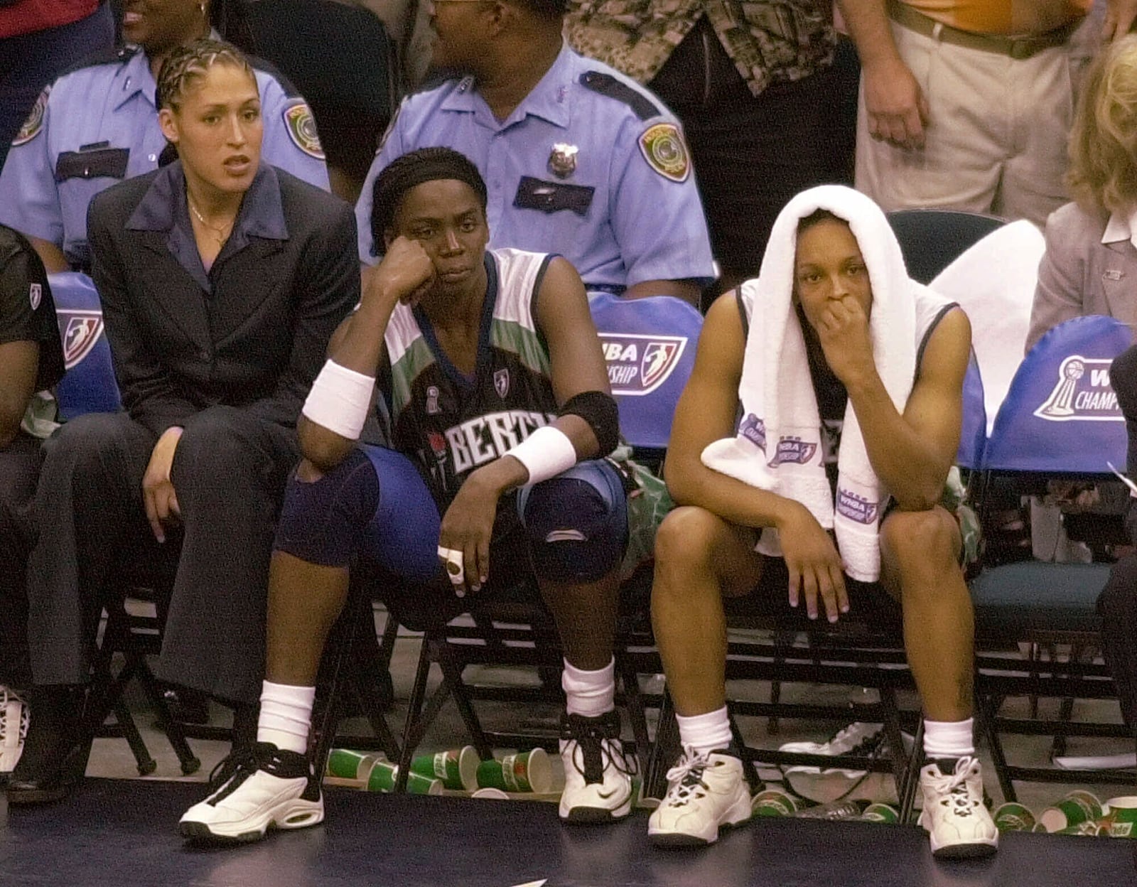 FILE - New York Liberty's Rebecca Lobo, left, Tari Phillips, center, and Teresa Weatherspoon watch from the bench in the final seconds against the Houston Comets in Game 2 of the WNBA Championship game, Aug. 26, 2000, in Houston. (AP Photo/Pat Sullivan, File)