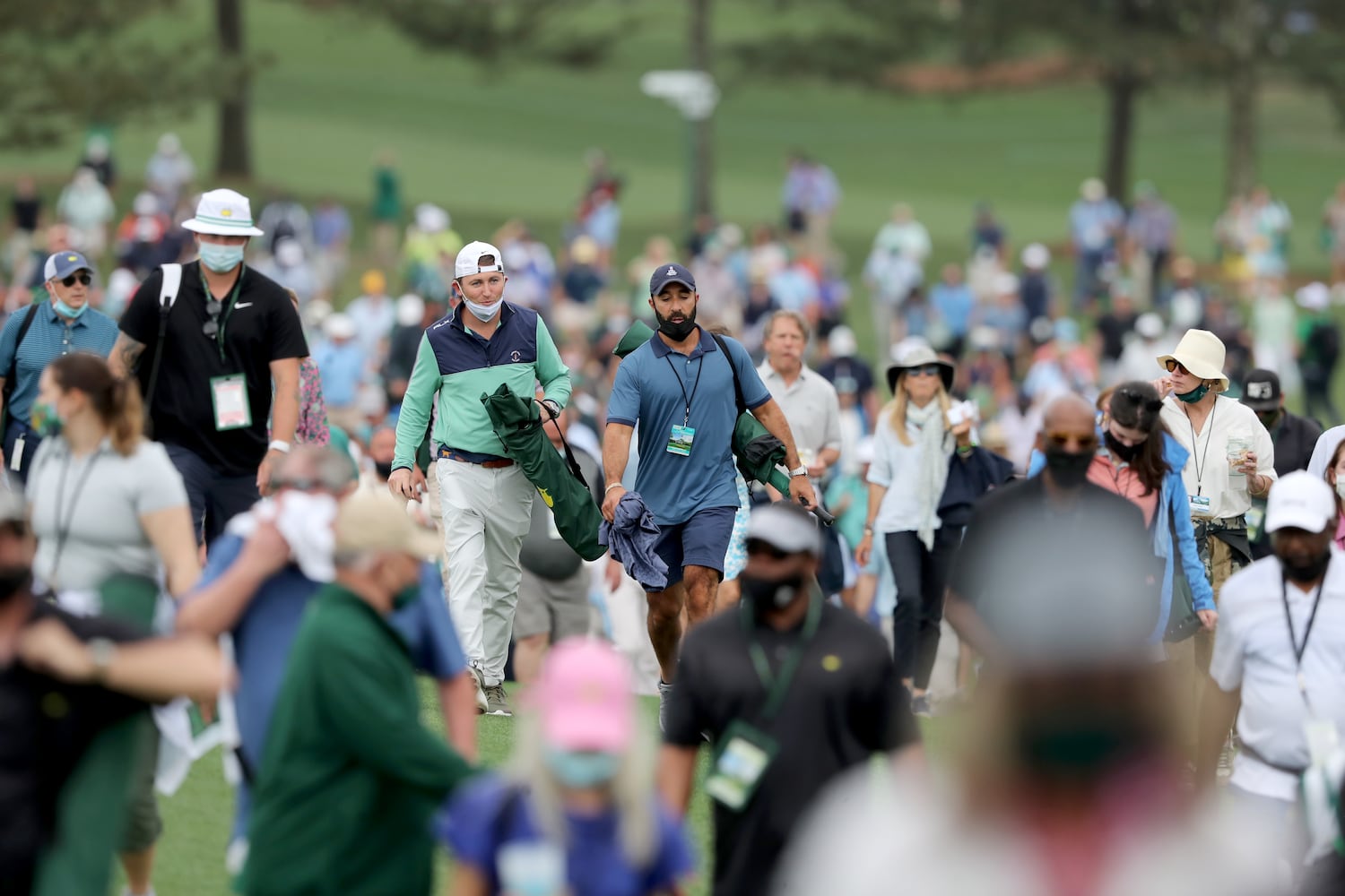 April 10, 2021, Augusta: Patrons leave the course as play is suspended because of a weather warning during the third round of the Masters at Augusta National Golf Club on Saturday, April 10, 2021, in Augusta. Curtis Compton/ccompton@ajc.com