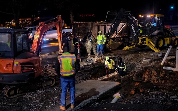 City of Atlanta Watershed Management workers replace a broken water pipe in Buckhead Friday morning. (Ben Hendren for the Atlanta Journal-Constitution)