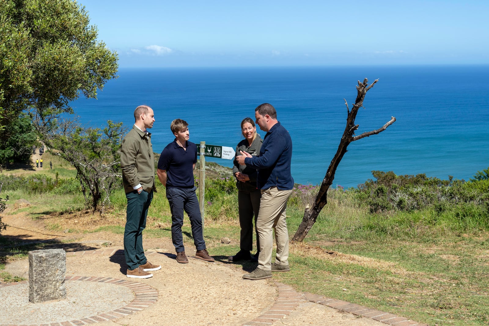 Britain's Prince William talks with Park Manager for Table Mountain National Park Megan Taplin, center right, Australian conservationist and Earthshot Prize global ambassador Robert Irwin, center left, and Cape Town mayor Geordin Hill-Lewis, right, in Cape Town, South Africa, Tuesday, Nov. 5, 2024. (AP Photo/Jerome Delay, Pool)