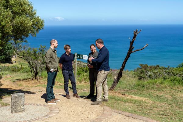 Britain's Prince William talks with Park Manager for Table Mountain National Park Megan Taplin, center right, Australian conservationist and Earthshot Prize global ambassador Robert Irwin, center left, and Cape Town mayor Geordin Hill-Lewis, right, in Cape Town, South Africa, Tuesday, Nov. 5, 2024. (AP Photo/Jerome Delay, Pool)