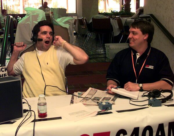 MIAMI, FL -- The long days and early morning shifts are finally getting to Atlanta sportscaster Jeff Hullinger (L,cq) who yawns during his 6am talk show on WGST as morning news anchor Paul Mann (R,cq) looks on from 'Radio Row' in the Super Bowl media center Friday morning 1/29/99. (LEVETTE BAGWELL/Staff)