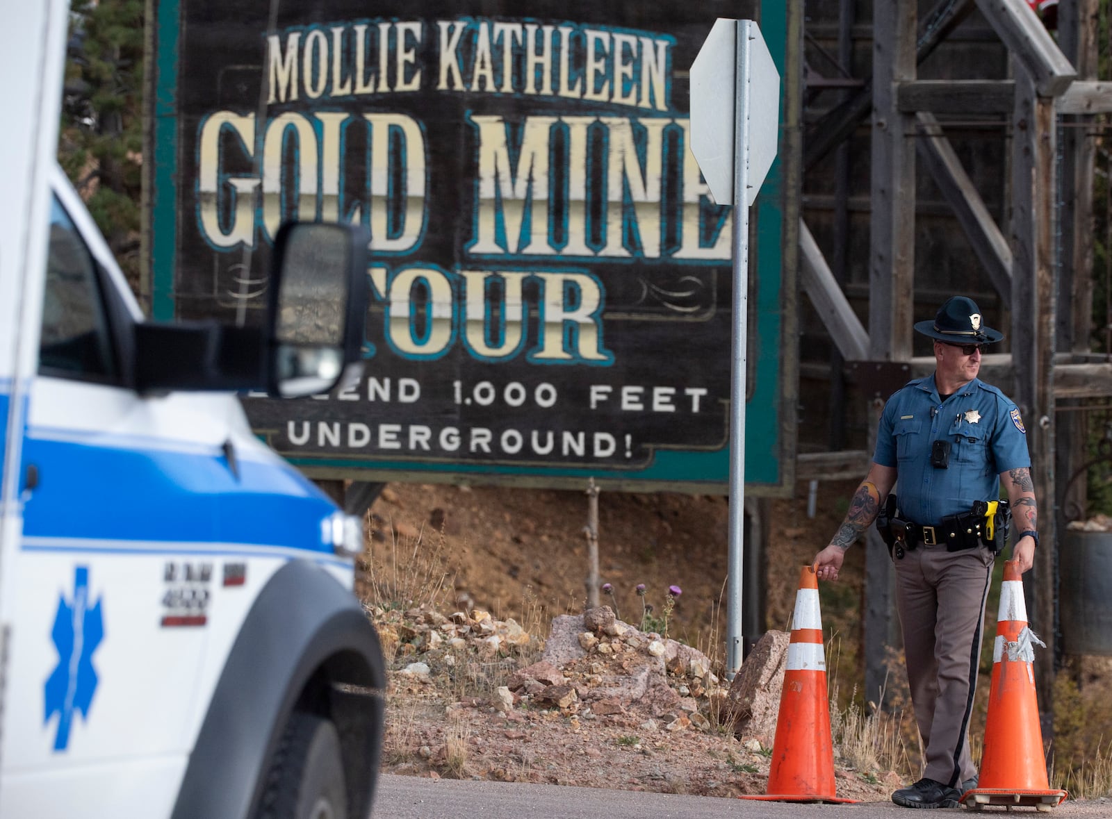 A police officer moves a barrier for an emergency vehicle Thursday, Oct. 9, 2024, at Mollie Kathleen Gold Mine in Cripple Creek, Colo. (Arthur H. Trickett-Wile/The Gazette via AP)