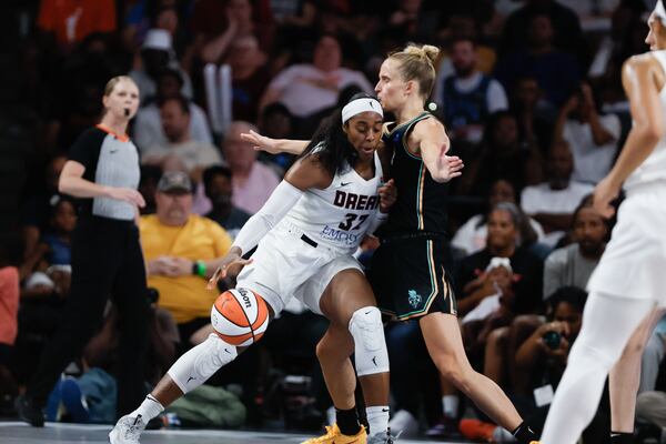 Atlanta Dream forward Cheyenne Parker-Tyus (32) drives the ball against New York Liberty forward Leonie Fiebich (13) during the second half against the New York Liberty on Sunday, June 23, 2024, in Atlanta, at Gateway Center Arena.  (Miguel Martinez / AJC)