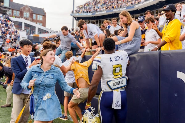 Georgia Tech wide receiver Avery Boyd (9) helps fans over the wall after the second half of an NCAA football game against Miami, Saturday, Nov. 9, 2024, in Atlanta. (AP Photo/Jason Allen)