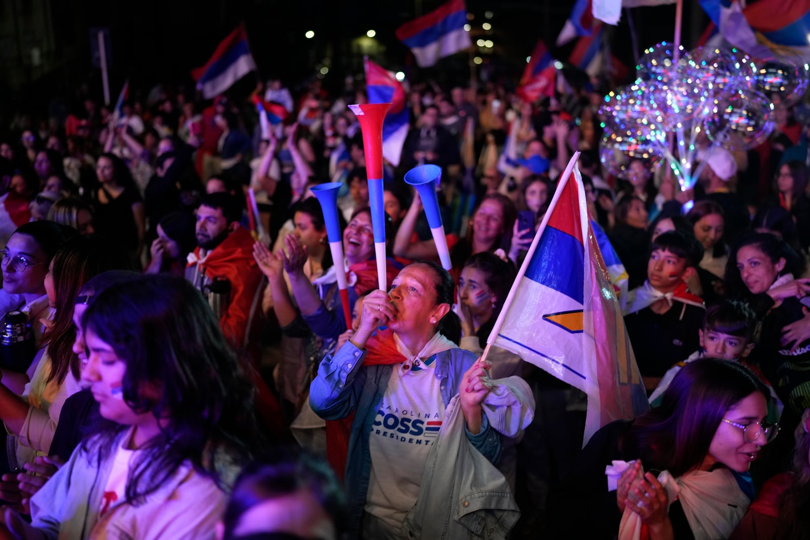 Frente Amplio supporters cheer at a gathering place outside a hotel after general election polls closed in Montevideo, Uruguay, Sunday, Oct. 27, 2024. (AP Photo/Natacha Pisarenko)