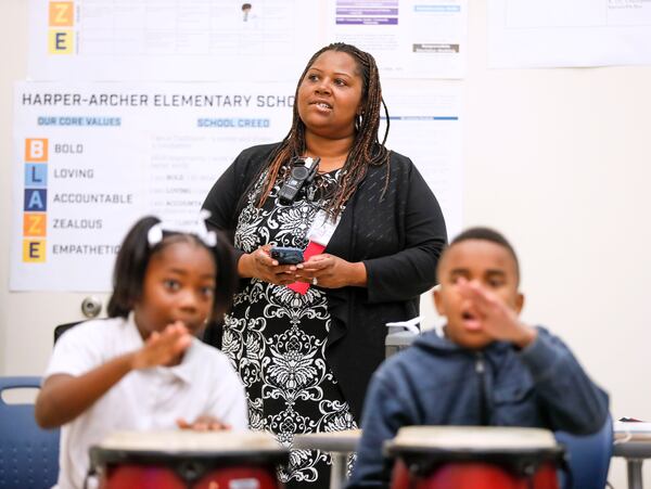 Principal Dione Simon Taylor stops in a music class to observe the teacher and takes observation notes on her phone while students drum. Bob Andres / robert.andres@ajc.com