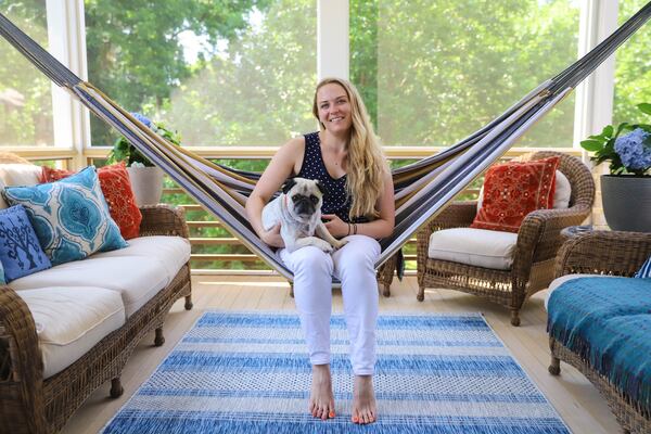 Emi Piez, an executive assistant for Portman Holdings, with her pug, Henry, purchased the home in Atlanta's West End neighborhood in 2016. The hammock, a gift, is one of the homeowner's favorite places to sit when hanging out with her friends and family.