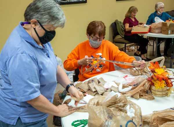 Bags2Blankets volunteers Deb Carrier (left) and Wanda Wenger help prepare plastic bags to be weaved into blankets at Tucker United Methodist Church. PHIL SKINNER FOR THE ATLANTA JOURNAL-CONSTITUTION.